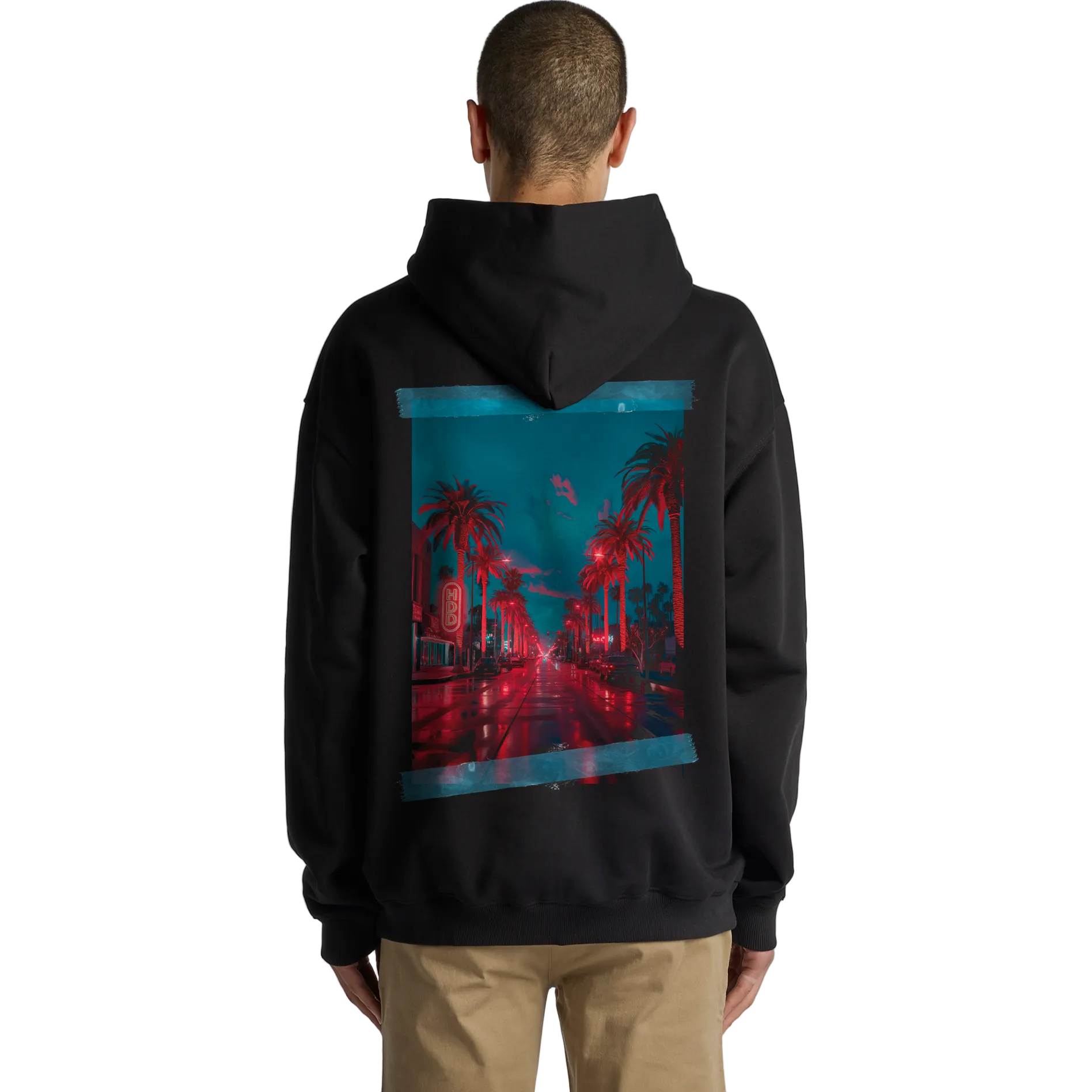 Person wearing a black hoodie with a colorful graphic on the back against a gray background
